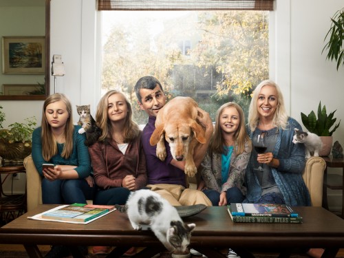 Seattle Humane family with dog and cats Family picture chaos with cats, a dog, and 3 teenage girls.